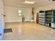 Spacious garage featuring a window, epoxy flooring, and built-in shelving units at 3914 E Constance Way, Phoenix, AZ 85042