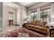 Inviting living room featuring a decorative rug, large windows, and neutral wall color at 3914 E Constance Way, Phoenix, AZ 85042