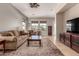 Open-concept living room with a warm color palette and access to the front entryway at 3914 E Constance Way, Phoenix, AZ 85042