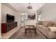 Comfortable living room with TV and an open view into the kitchen area at 3914 E Constance Way, Phoenix, AZ 85042