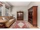 Cozy living room with wood floors, large windows, and decorative display cabinets at 3914 E Constance Way, Phoenix, AZ 85042