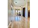 Open living area with hardwood floors, modern desk setup, and stylish built-in shelving at 3914 E Constance Way, Phoenix, AZ 85042