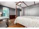 Comfortable primary bedroom with a four-poster bed, hardwood floors, and access to a colorful bathroom at 3914 E Constance Way, Phoenix, AZ 85042
