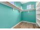 Well-organized walk-in closet with custom shelving and ample storage space in a light blue color at 3914 E Constance Way, Phoenix, AZ 85042