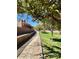 Serene community walkway surrounded by lush greenery, flowering bushes, and mature trees at 3914 E Constance Way, Phoenix, AZ 85042