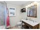 Bathroom featuring a single sink vanity, decorative mirror, and a shower with colorful curtain at 3931 W Augusta Ave, Phoenix, AZ 85051