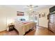 Bright bedroom featuring patio doors to pool and ceiling fan at 3931 W Augusta Ave, Phoenix, AZ 85051
