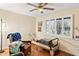 Sunlit room featuring workout equipment, chair and a ceiling fan, offering a blend of relaxation and exercise at 3931 W Augusta Ave, Phoenix, AZ 85051