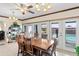Dining area with a wooden table, ceiling fan, and glass doors leading to the pool area at 3931 W Augusta Ave, Phoenix, AZ 85051