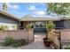 Cozy entryway with a brick accent wall, wooden gate and lush potted plants adding warmth and charm at 3931 W Augusta Ave, Phoenix, AZ 85051