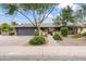 Charming single-story home with a manicured front yard, brick driveway, and cozy curb appeal in daytime at 3931 W Augusta Ave, Phoenix, AZ 85051