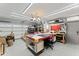 Spacious garage featuring lighting, large work table, and garage door at 3931 W Augusta Ave, Phoenix, AZ 85051