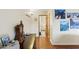 Hallway featuring wood floors, wall decor, and doors leading to various rooms at 3931 W Augusta Ave, Phoenix, AZ 85051