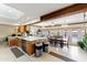 Open-concept kitchen with an island, connecting to the dining area and views of the pool at 3931 W Augusta Ave, Phoenix, AZ 85051