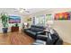 Cozy living room featuring leather seating, vibrant art, and bright natural light from the shuttered windows at 3931 W Augusta Ave, Phoenix, AZ 85051