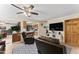 Comfortable living room with leather seating, ceiling fan, and an open view into the kitchen at 3931 W Augusta Ave, Phoenix, AZ 85051