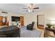 Cozy living room with blue patterned rug, wooden doors, and a ceiling fan at 3931 W Augusta Ave, Phoenix, AZ 85051