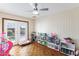 Bright playroom with hardwood floors, filled with toys and offering access to the backyard at 3931 W Augusta Ave, Phoenix, AZ 85051