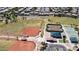 Aerial view of a well-maintained community park featuring baseball and tennis courts at 41961 W Centennial Rd, Maricopa, AZ 85138