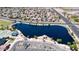 Aerial view of a community with a lake, showcasing the neighborhood layout and surrounding amenities at 41961 W Centennial Rd, Maricopa, AZ 85138
