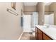 Bathroom featuring a single sink, toilet, and bathtub with a curtain at 41961 W Centennial Rd, Maricopa, AZ 85138