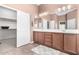 Bathroom featuring a double vanity and walk in closet at 41961 W Centennial Rd, Maricopa, AZ 85138