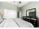 Bedroom with a dresser, TV, and large closet with white doors at 41961 W Centennial Rd, Maricopa, AZ 85138