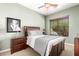 Bedroom featuring a large window, wooden bed frame, and matching nightstand at 41961 W Centennial Rd, Maricopa, AZ 85138