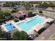 Aerial view of the community pool and shaded lounge area with desert landscaping at 41961 W Centennial Rd, Maricopa, AZ 85138