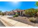 Charming single-story home showcasing a well-maintained front yard and an attached two-car garage at 41961 W Centennial Rd, Maricopa, AZ 85138