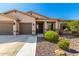 Charming single-story home showcasing a well-maintained front yard and an attached two-car garage at 41961 W Centennial Rd, Maricopa, AZ 85138