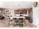 Open kitchen with marble counters, stainless steel appliances, and a large island with seating at 41961 W Centennial Rd, Maricopa, AZ 85138