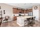 Stylish kitchen featuring stainless steel appliances, ample counter space, and an island with bar stools at 41961 W Centennial Rd, Maricopa, AZ 85138