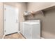 Laundry room with a washer, dryer, and shelf space for storage at 41961 W Centennial Rd, Maricopa, AZ 85138