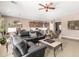 Open-concept living room with a comfortable sectional sofa, connecting to the kitchen and dining area at 41961 W Centennial Rd, Maricopa, AZ 85138