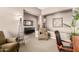 Bright living area with neutral tones, fireplace and natural light. Decor includes framed art and green houseplant at 41961 W Centennial Rd, Maricopa, AZ 85138