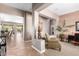A cozy living area with neutral tones, tile flooring and natural light filtering through a large patio window at 41961 W Centennial Rd, Maricopa, AZ 85138