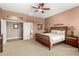 Spacious main bedroom with a ceiling fan and wooden bed frame at 41961 W Centennial Rd, Maricopa, AZ 85138