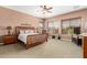 Serene primary bedroom with natural light and comfortable furnishings at 41961 W Centennial Rd, Maricopa, AZ 85138