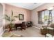 Bright office space features natural light, neutral paint, large plant, and dark wood desk at 41961 W Centennial Rd, Maricopa, AZ 85138