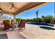 Covered patio featuring a ceiling fan, outdoor seating, and a pool with a spa at 41961 W Centennial Rd, Maricopa, AZ 85138
