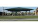 Well maintained playground with a large shade structure in a Gathering friendly neighborhood at 41961 W Centennial Rd, Maricopa, AZ 85138