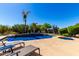 Backyard pool and spa surrounded by lush landscaping and a blue sky at 41961 W Centennial Rd, Maricopa, AZ 85138