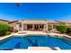 Inviting backyard pool with spa and a covered patio, perfect for entertaining at 41961 W Centennial Rd, Maricopa, AZ 85138