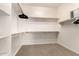 Walk-in closet with built-in shelving and wooden rods for ample storage at 41961 W Centennial Rd, Maricopa, AZ 85138