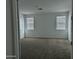 Spacious bedroom with neutral carpet, two windows, and ample natural light at 4330 N 94Th Ave, Phoenix, AZ 85037