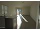 Sunlit living area showcases tile floors, white walls, and kitchen with stainless steel dishwasher and appliances at 4330 N 94Th Ave, Phoenix, AZ 85037