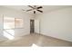 Cozy bedroom with neutral carpet and paint and a view of the Primary bath and walk in closet at 44583 W Windrose Dr, Maricopa, AZ 85138