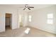 Comfortable bedroom with neutral walls, carpeted flooring, ceiling fan, and ample natural light at 44583 W Windrose Dr, Maricopa, AZ 85138