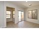 Bright dining room with tile flooring, large windows, and sliding glass door leading to the backyard at 44583 W Windrose Dr, Maricopa, AZ 85138